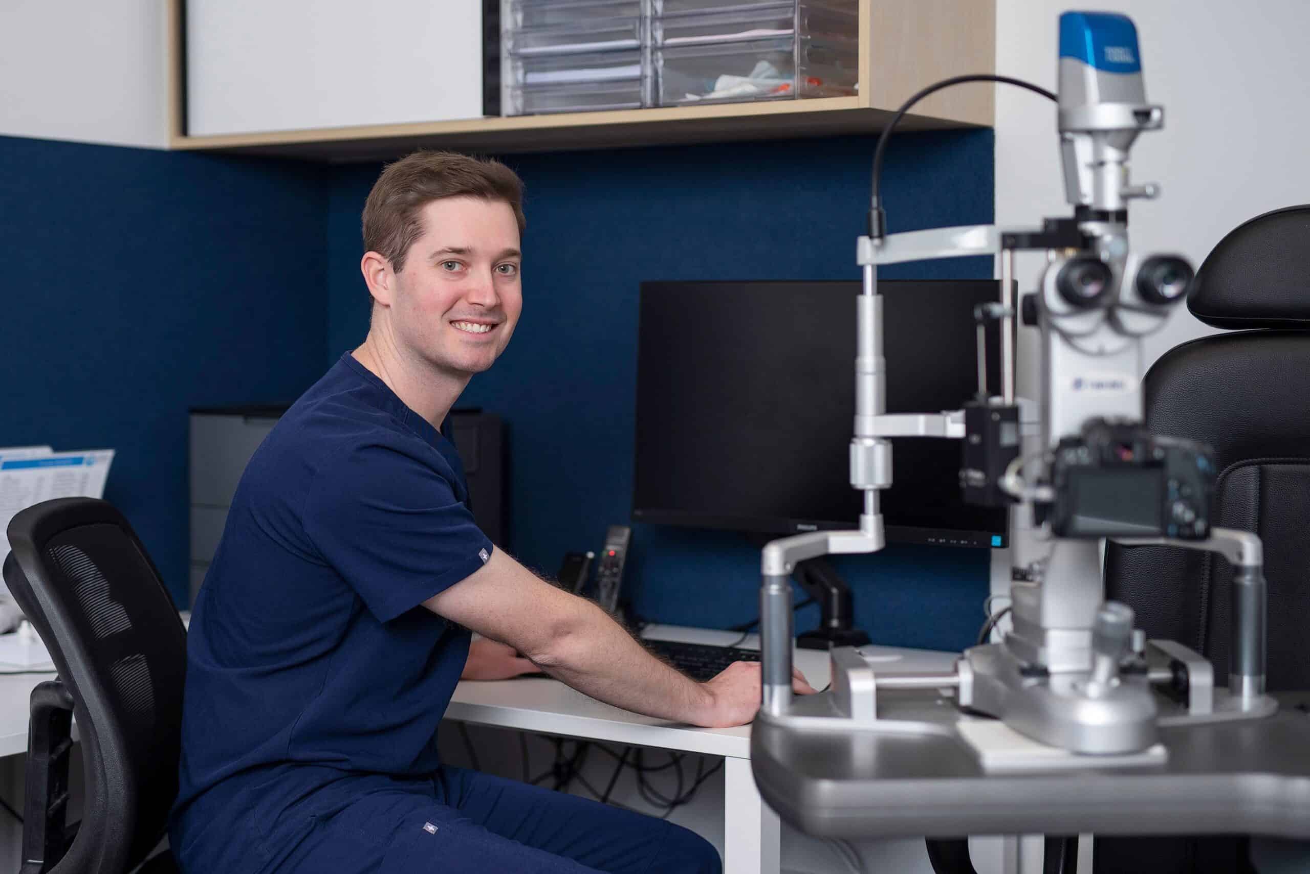 Dr Geoffrey Ryan smiling in his office