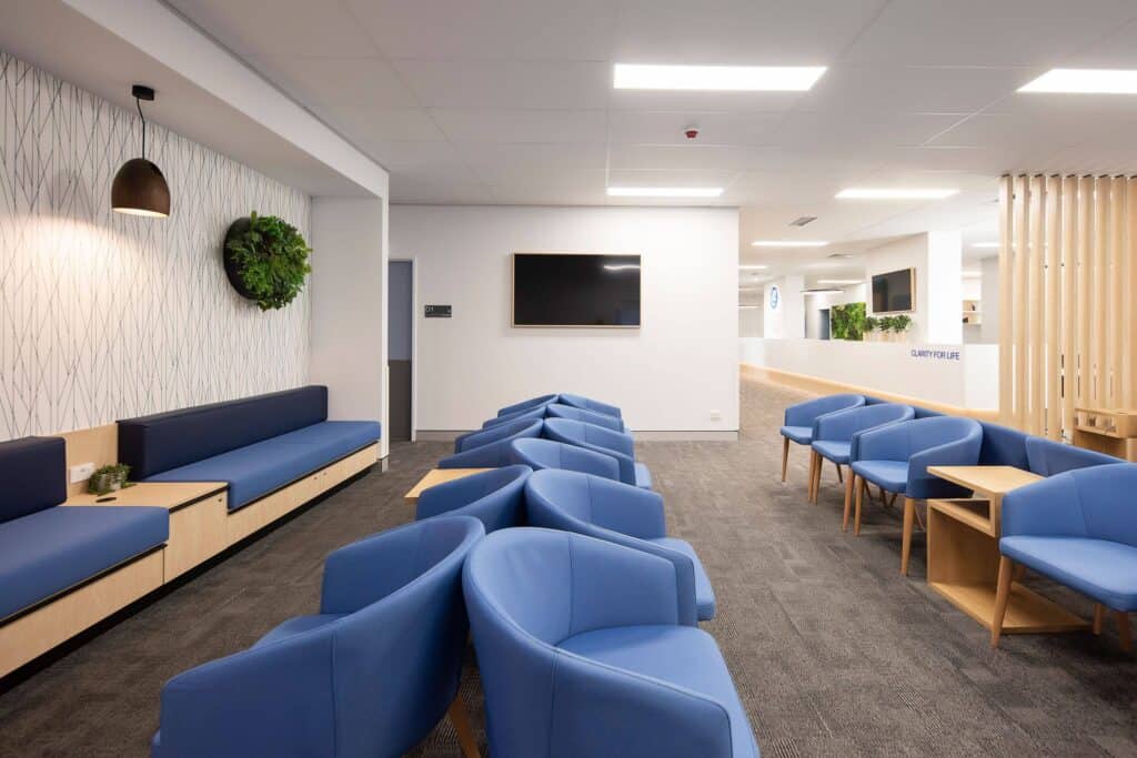 Large waiting room full of blue chairs