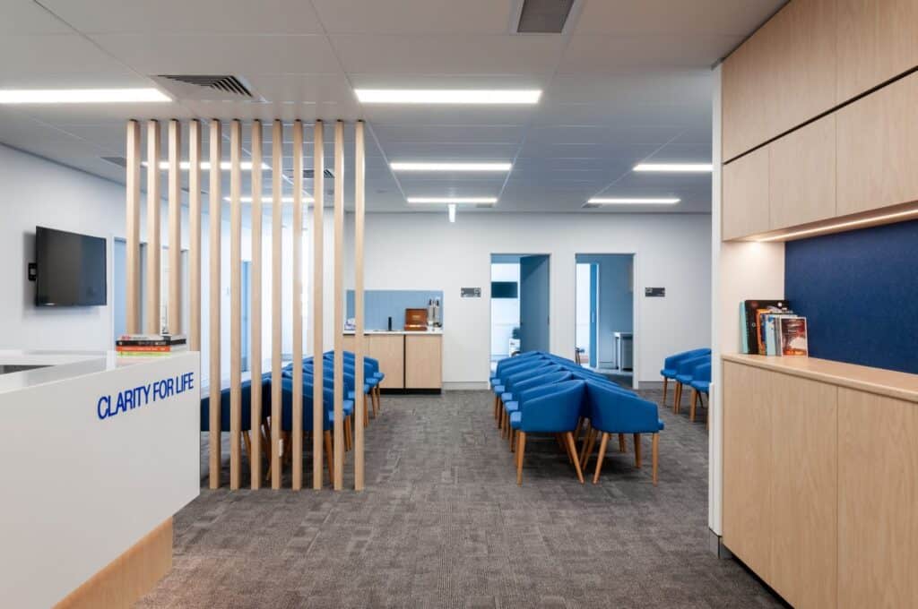 Large waiting room area with blue chairs