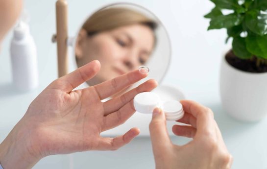 Woman with a contact lense on her finger ready to put it in