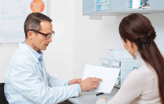 Eye doctor speaking to a patient