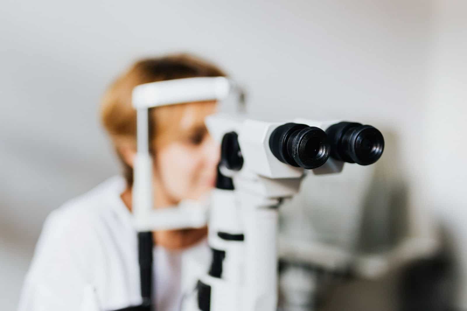 patient looking through lens to determine whether cataracts are needed