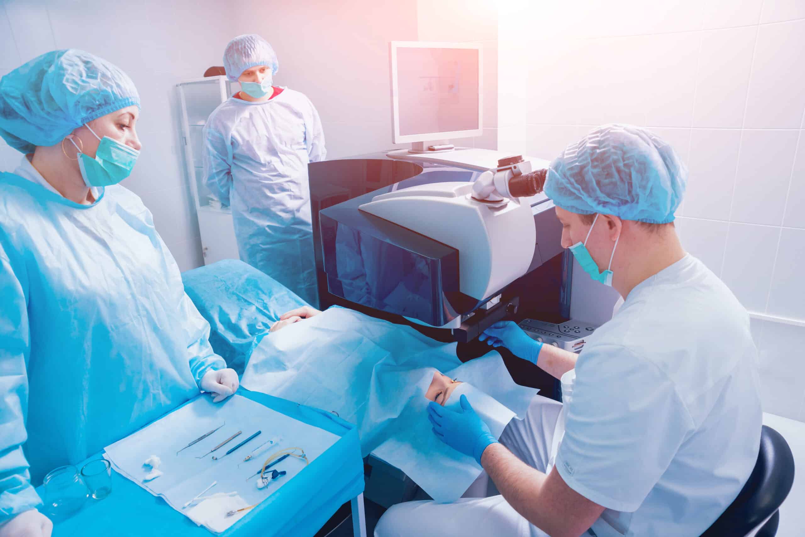 Medical professionals performing eye surgery