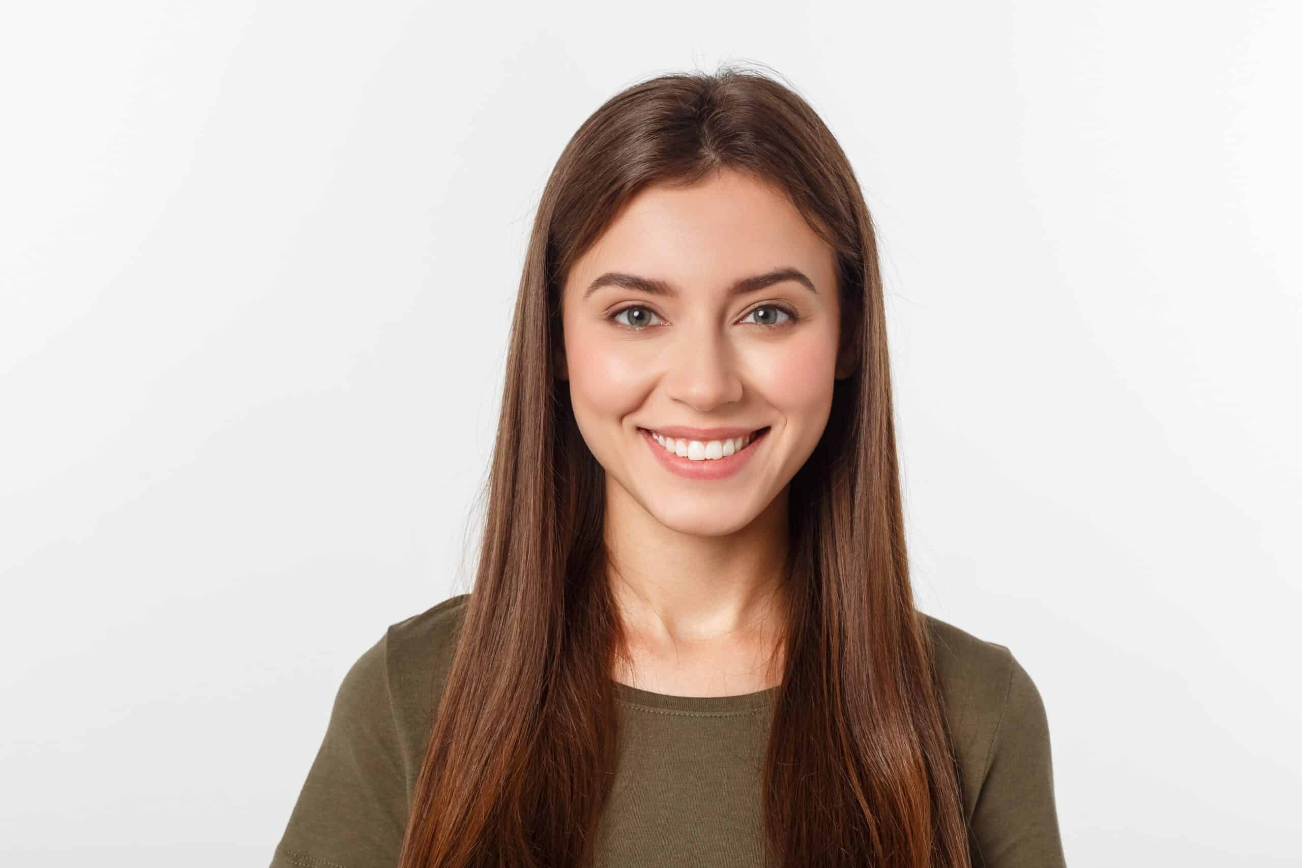 woman smiling at the camera after eye surgery