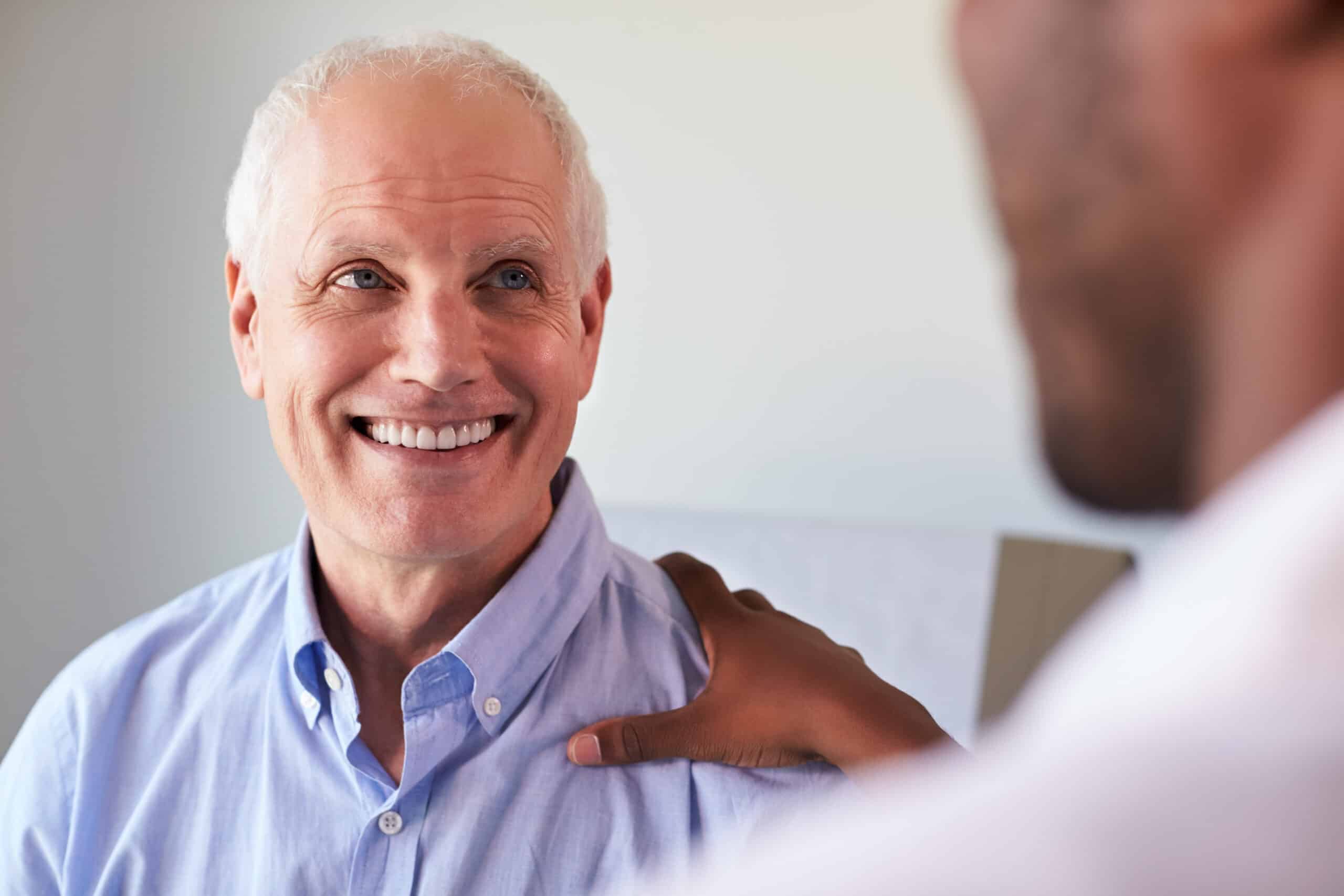 Doctor meeting with mature male to discuss corneal conditions